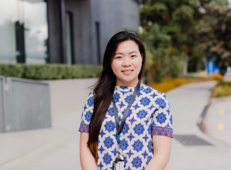 A Health New Zealand ESC nurse standing outside the hospital smiling